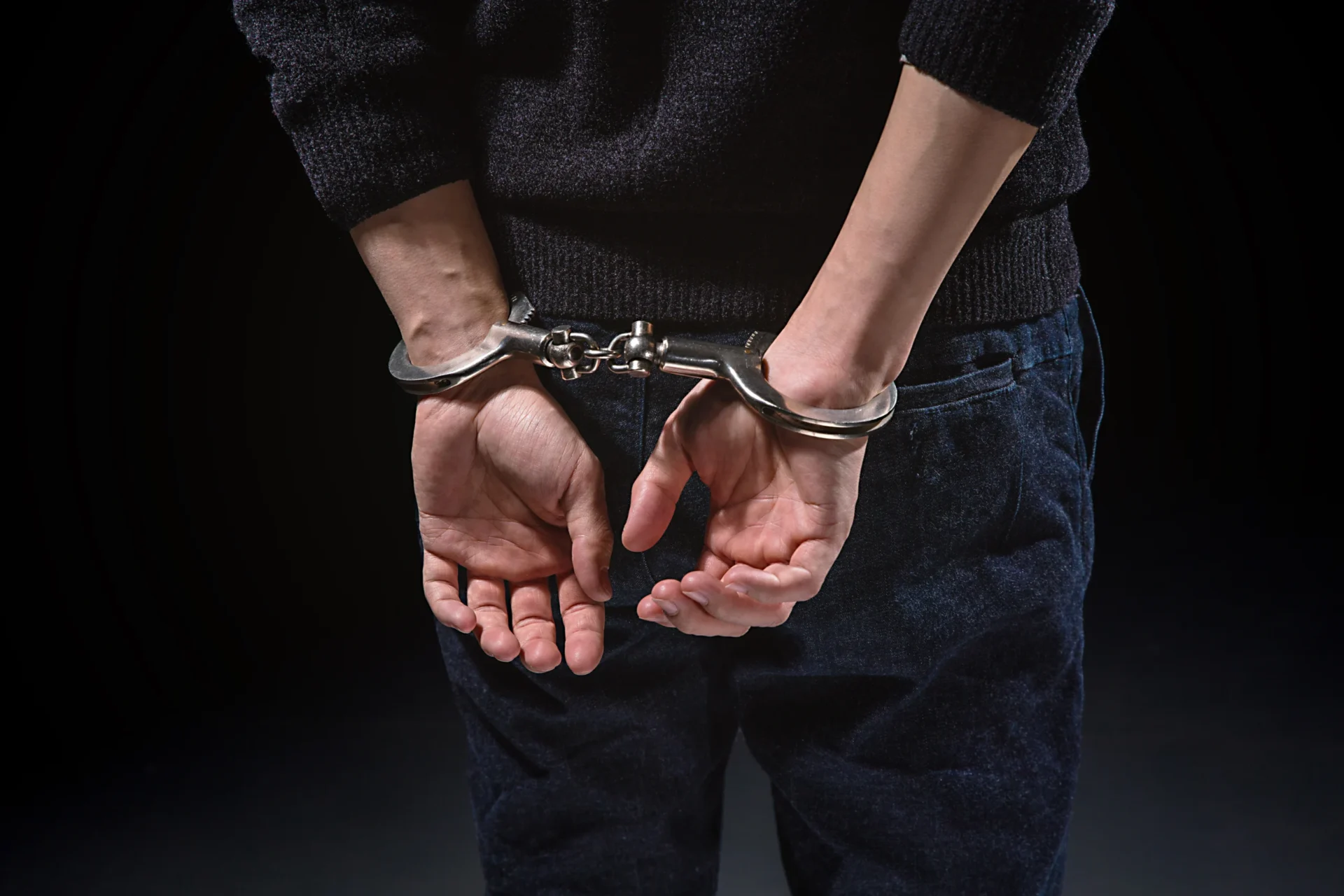 A man is restrained in handcuffs