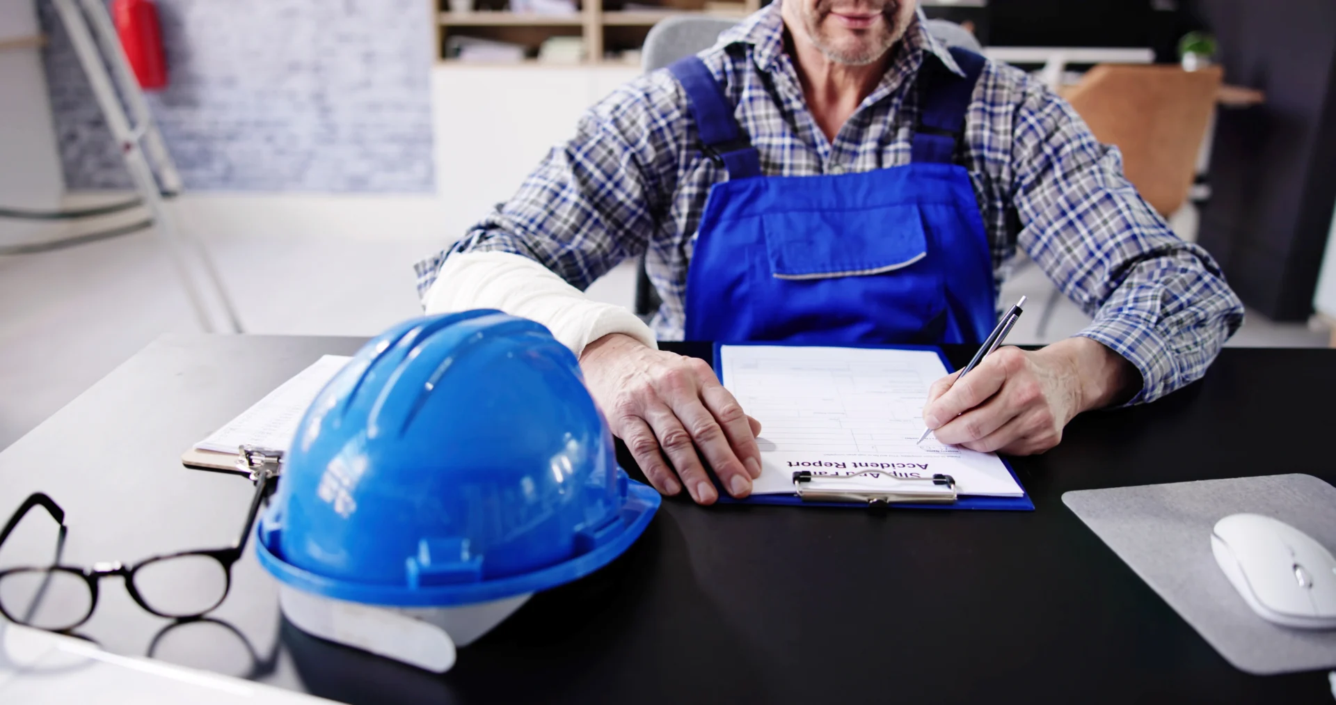 A construction worker fills out an application at a desk