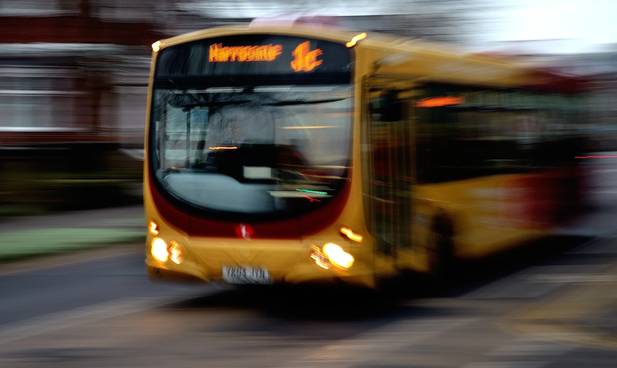 A city bus driving on a street