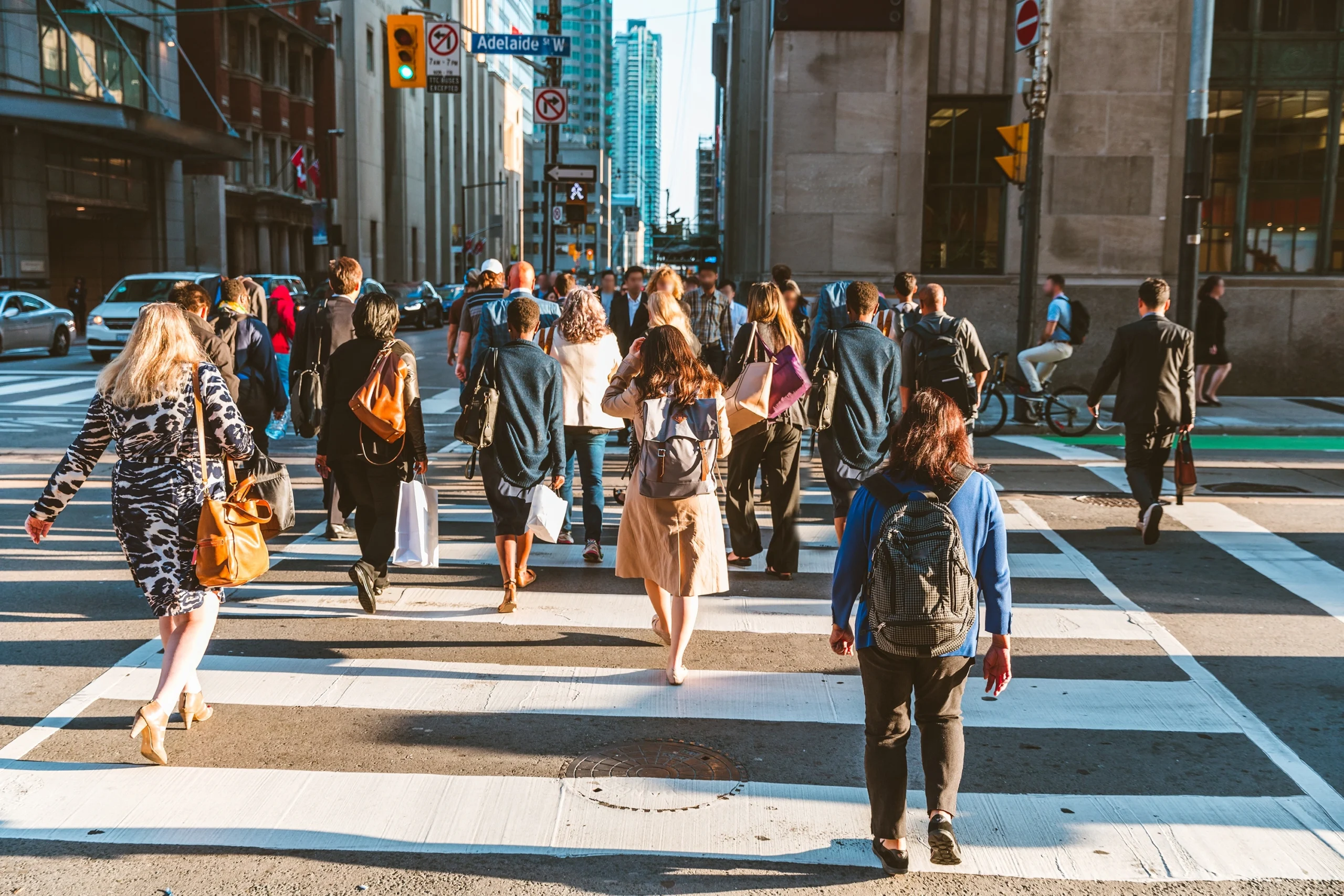 Pedestrians crossing the street in a crosswalk in a bustling city