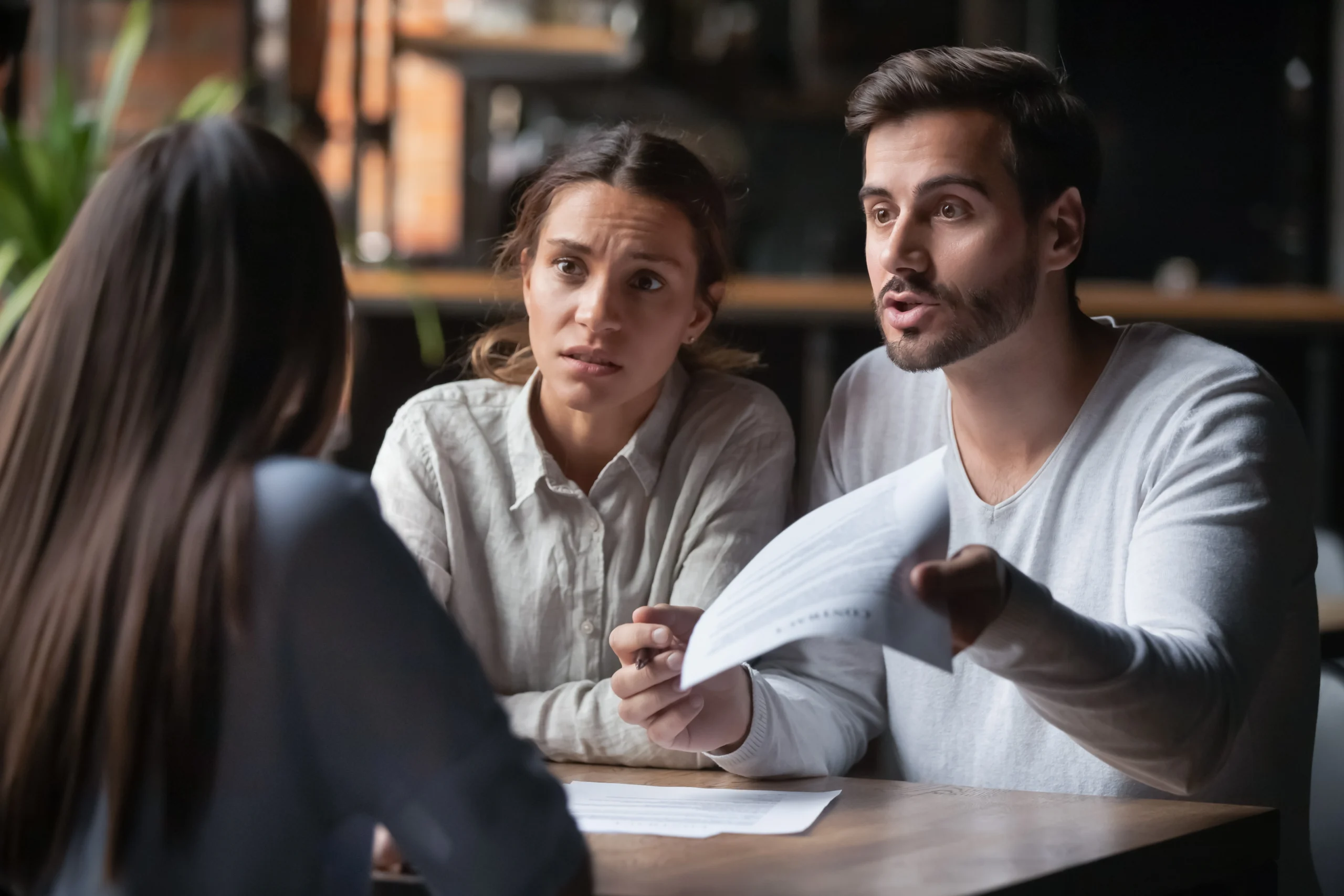 A couple argues while holding a contract