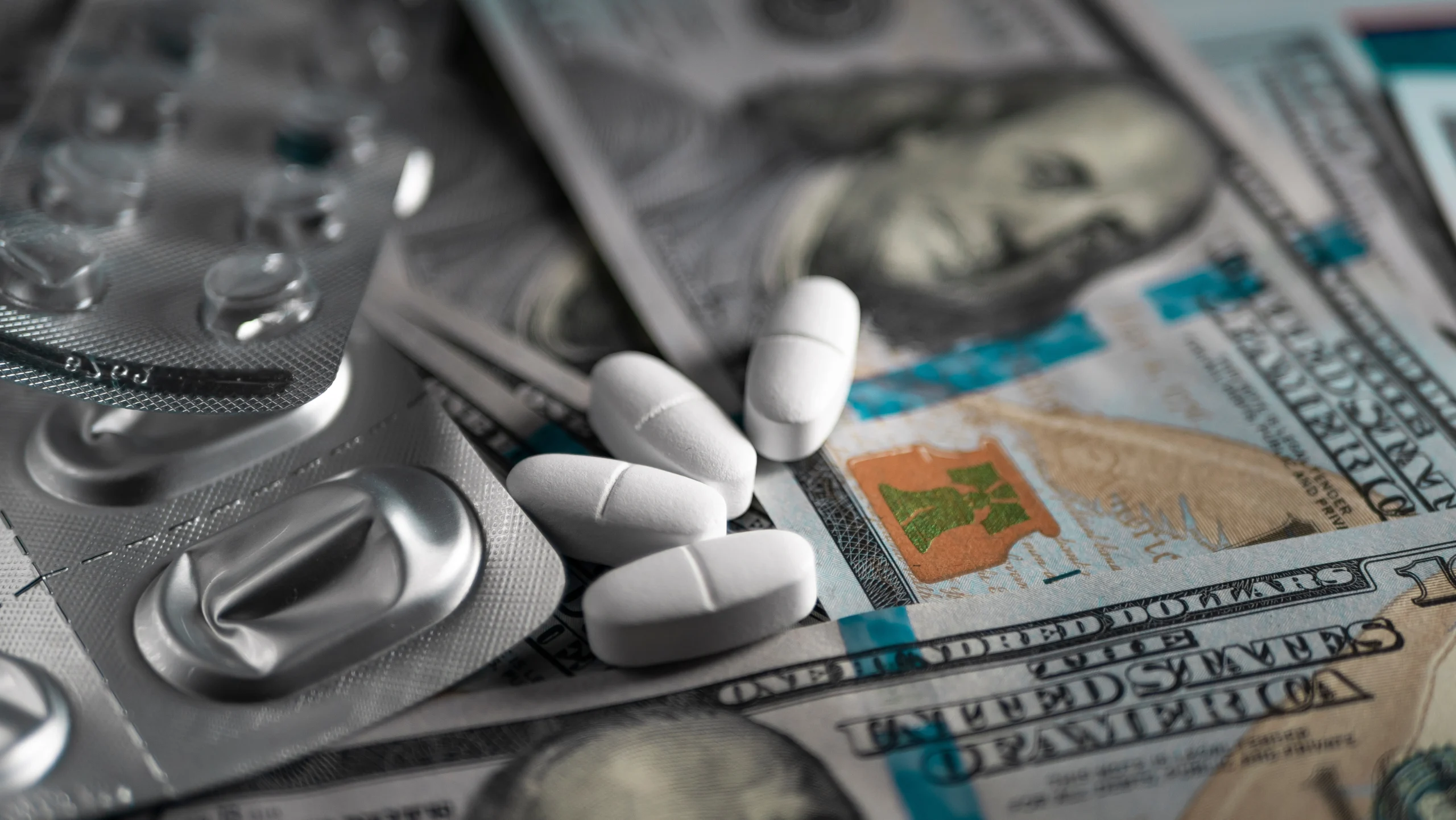 Pills sit on top of money