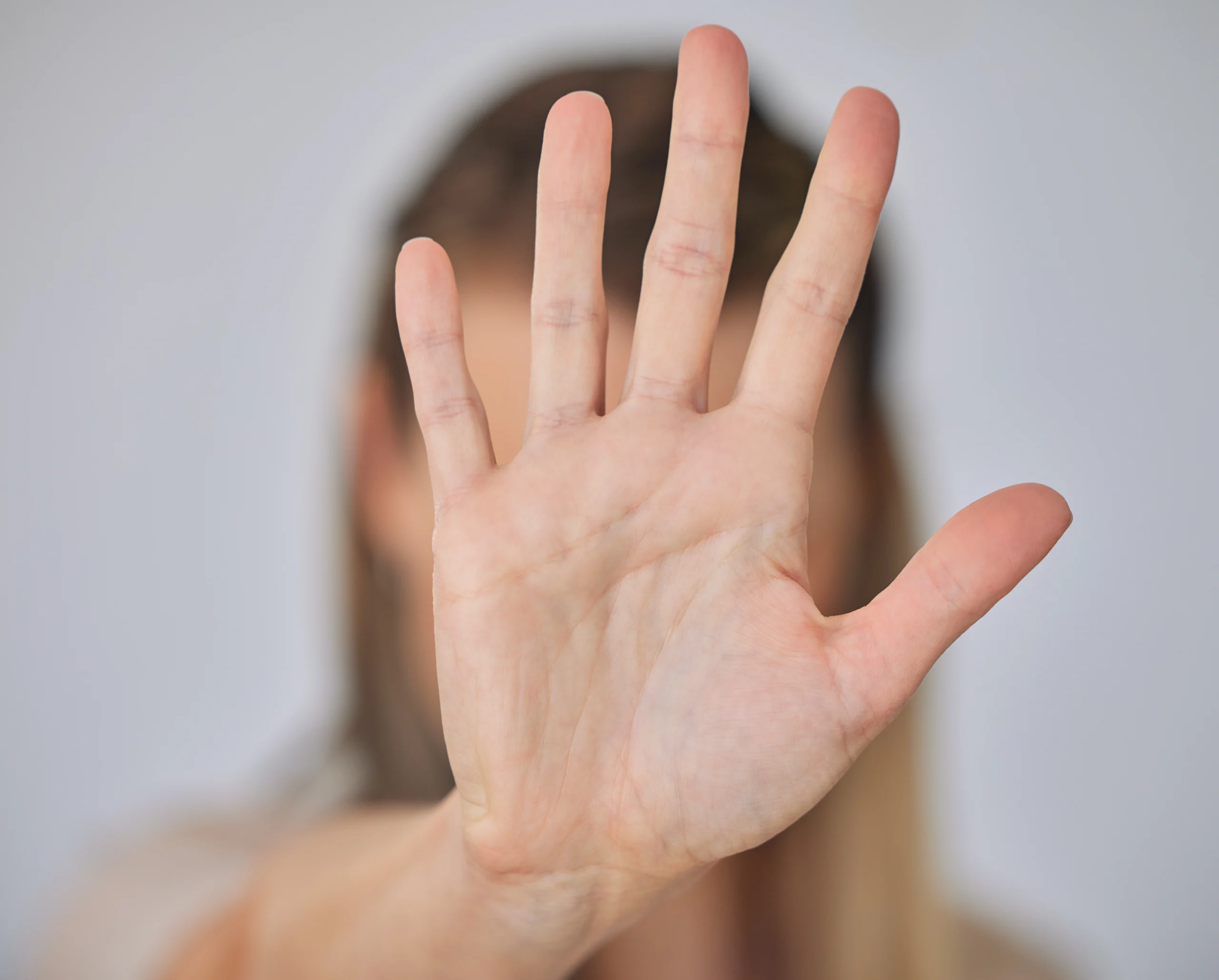 A hand is held up to say stop