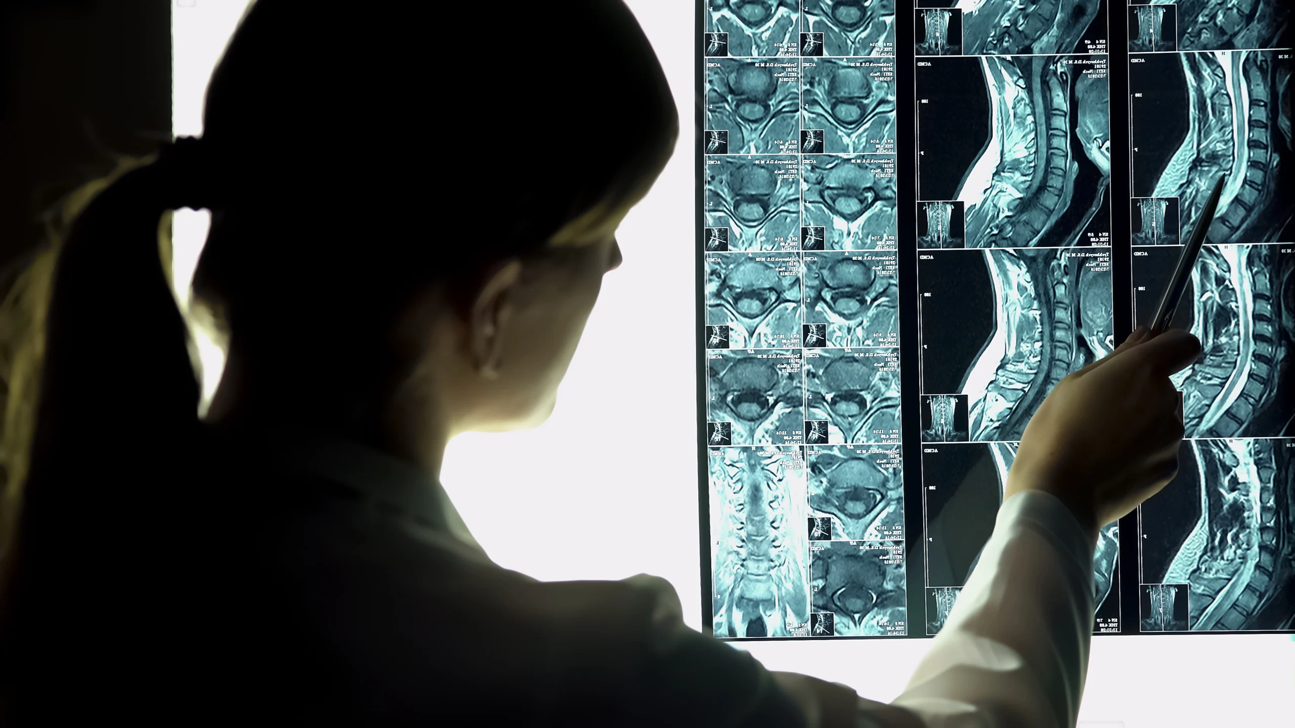 A health professional reviews spinal x-rays